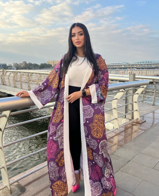 A colorful kaftan with statement cuffs for a bold, elegant look.